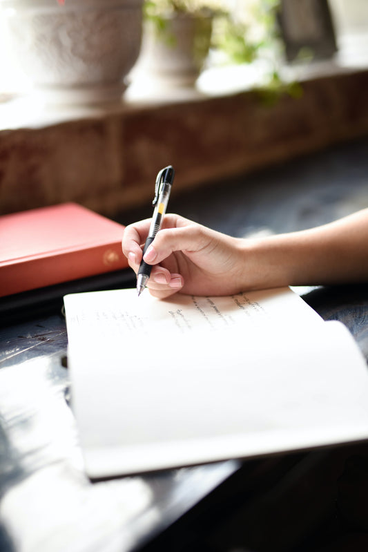 woman writing in a journal 